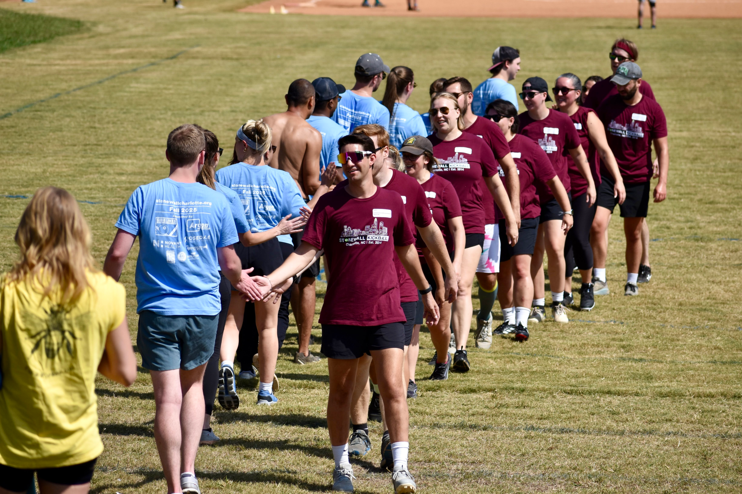 Kickball teams high five after a game Kickball teams high five after a game